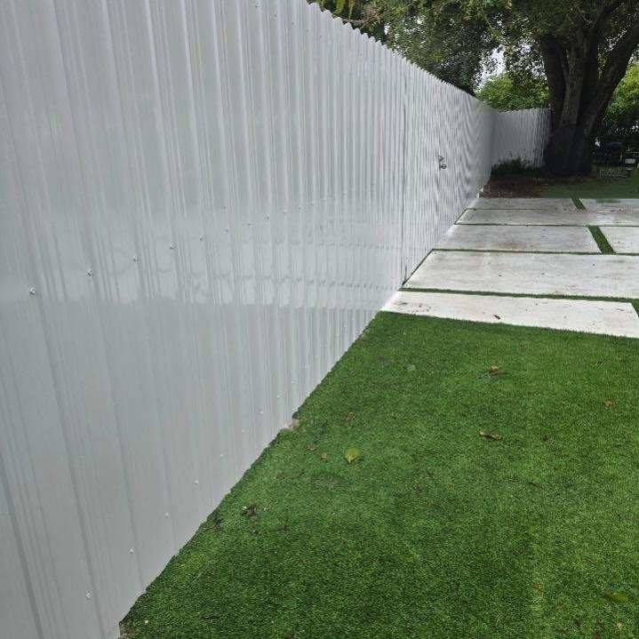 Durafence install — galvanized steel privacy panels, white powder-coat, South Florida.